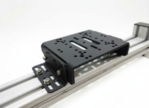 A close-up of the Simforge Universal Wheelbase Mount, a heavy-duty steel plate designed for high-torque direct drive wheels including Fanatec, MOZA, Simagic, and Asetek.