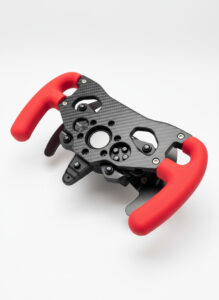 A driver's point-of-view gripping the ergonomic red PLA handles on the Thrustmaster T300 F1 wheel addon during an F1 simulator race, highlighting control and comfort
